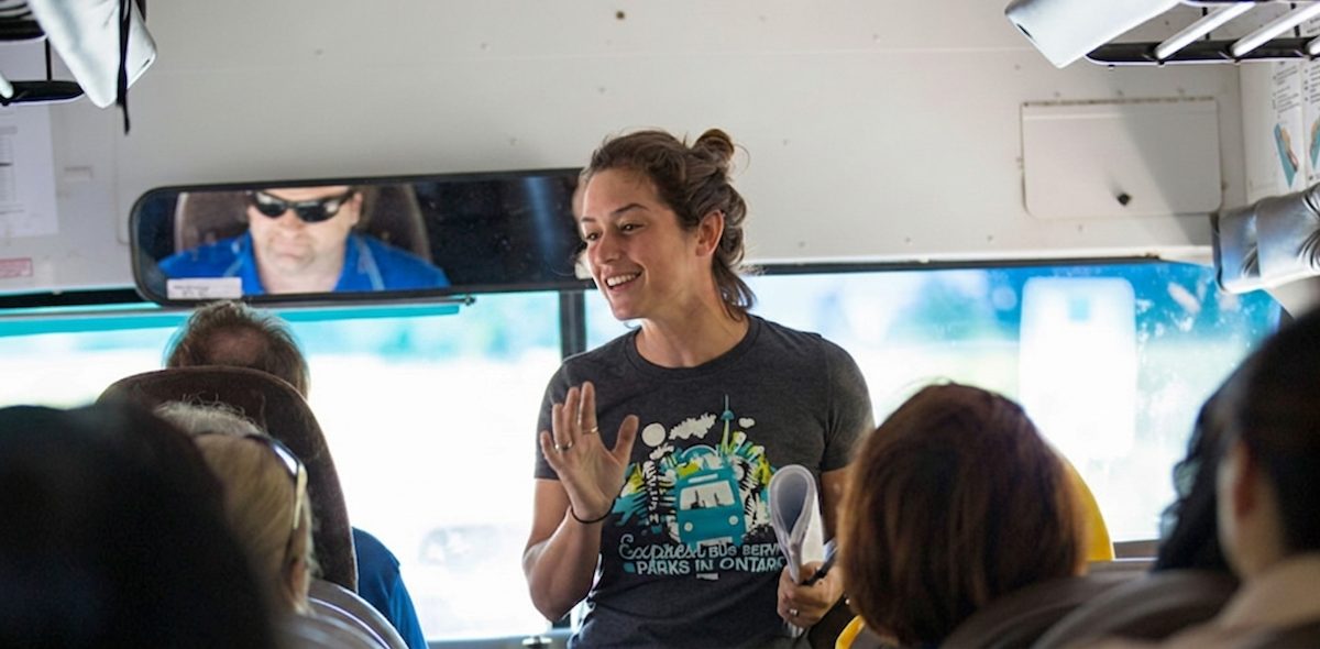 A Parkbus guide talking with passengers on the bus